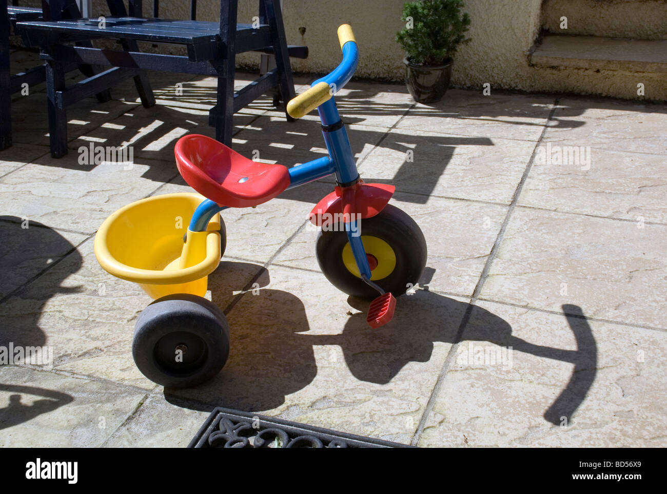 Homage to photographer William Eggleston,patio and childs toys,drive, energetic, fast, happy, high, high-key, highkey, isolated, Stock Photo