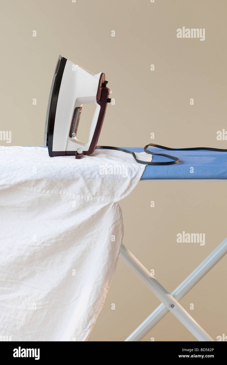An ironing board with an iron Stock Photo