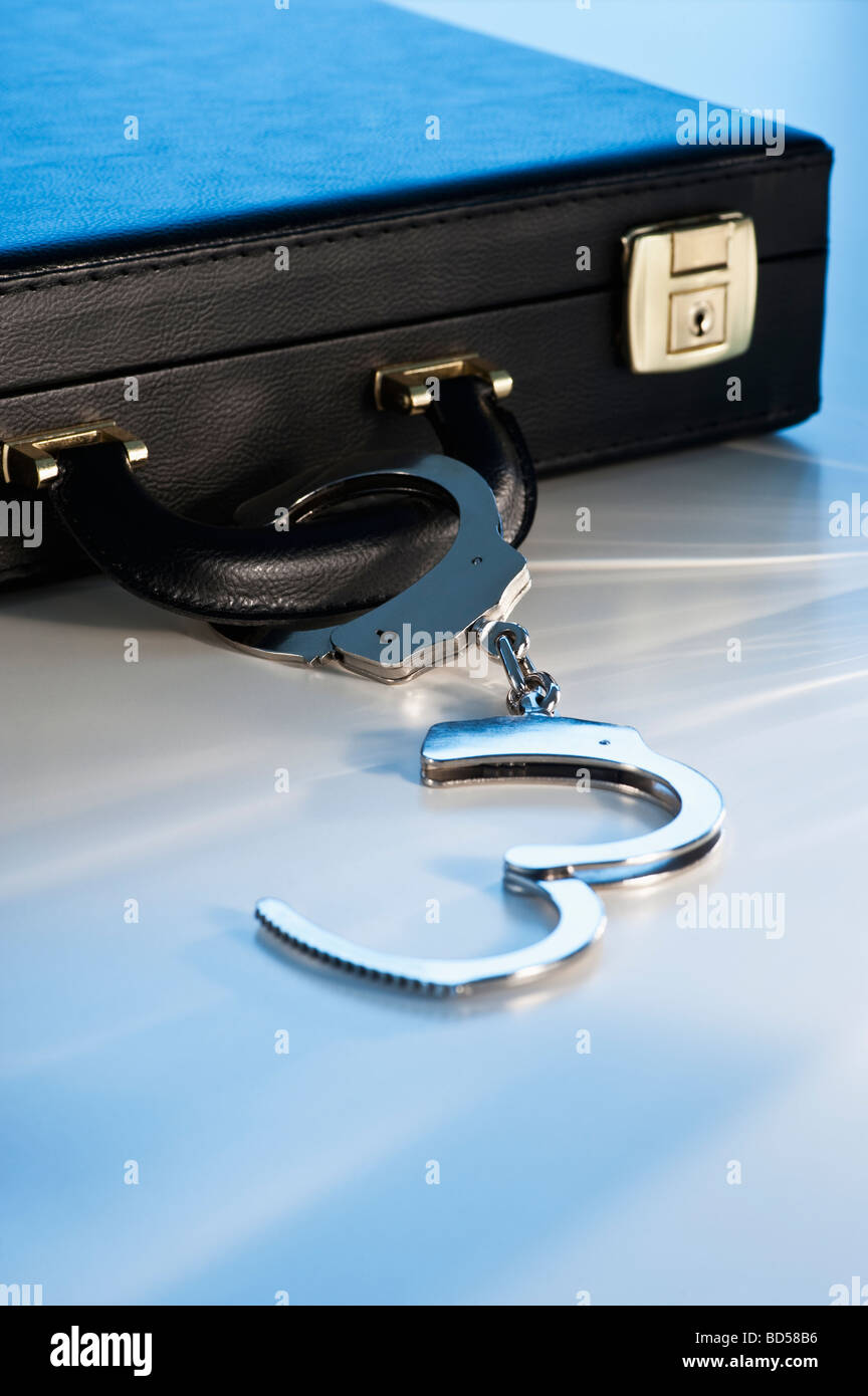 Hand cuffs attached to a suitcase Stock Photo
