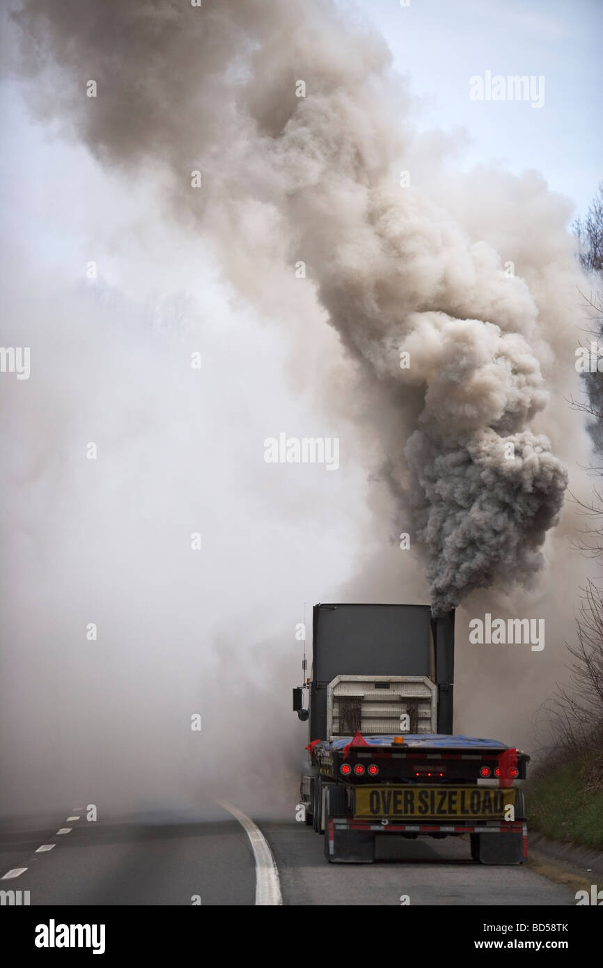 Large semi truck emitting exhaust fumes Stock Photo