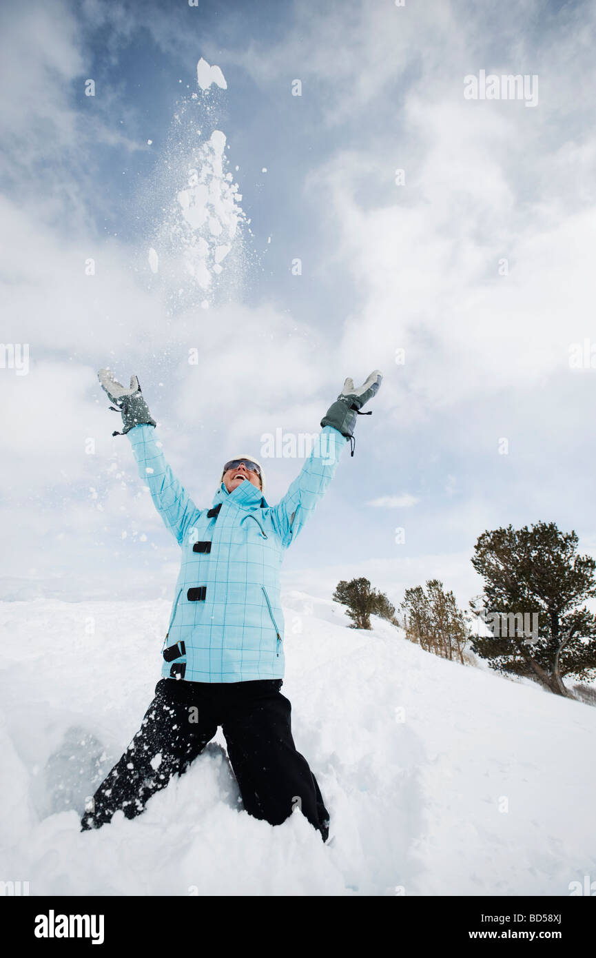 A woman throwing snow up in air Stock Photo Alamy