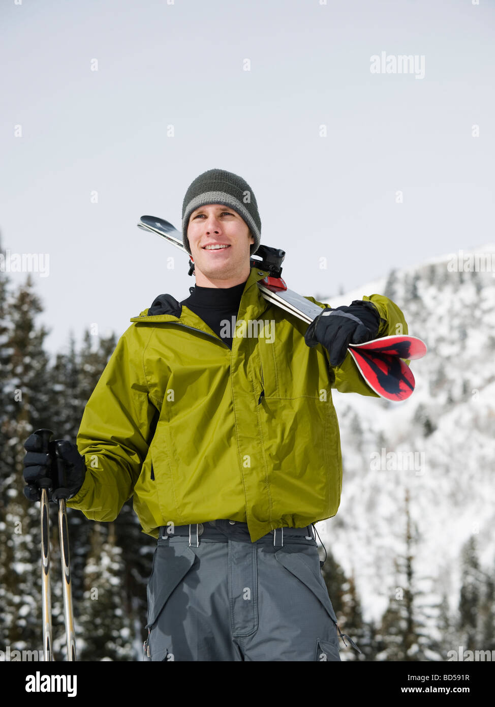A downhill skier carrying skis Stock Photo Alamy