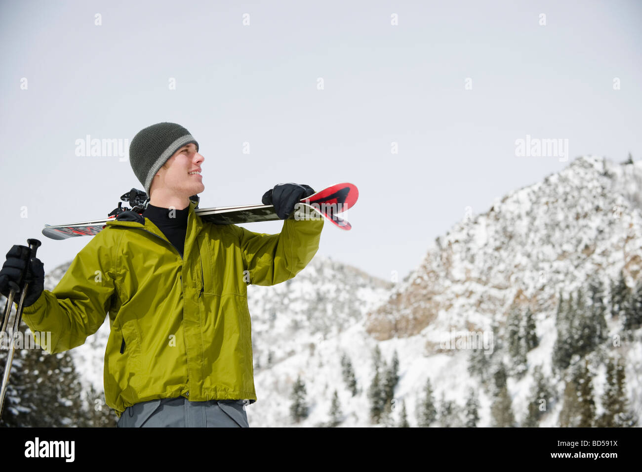 A downhill skier carrying skis Stock Photo Alamy