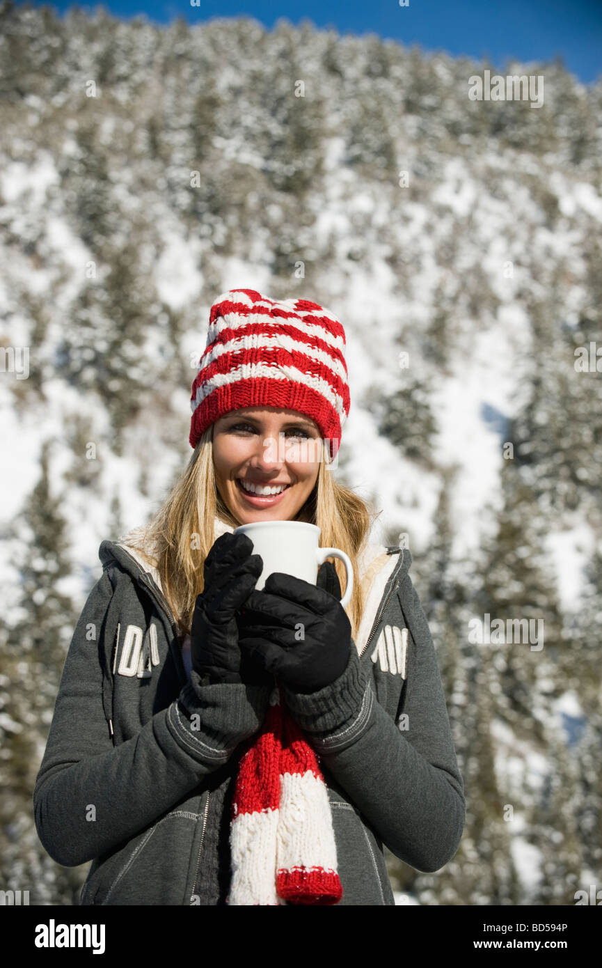 A woman with a mug outdoors Stock Photo