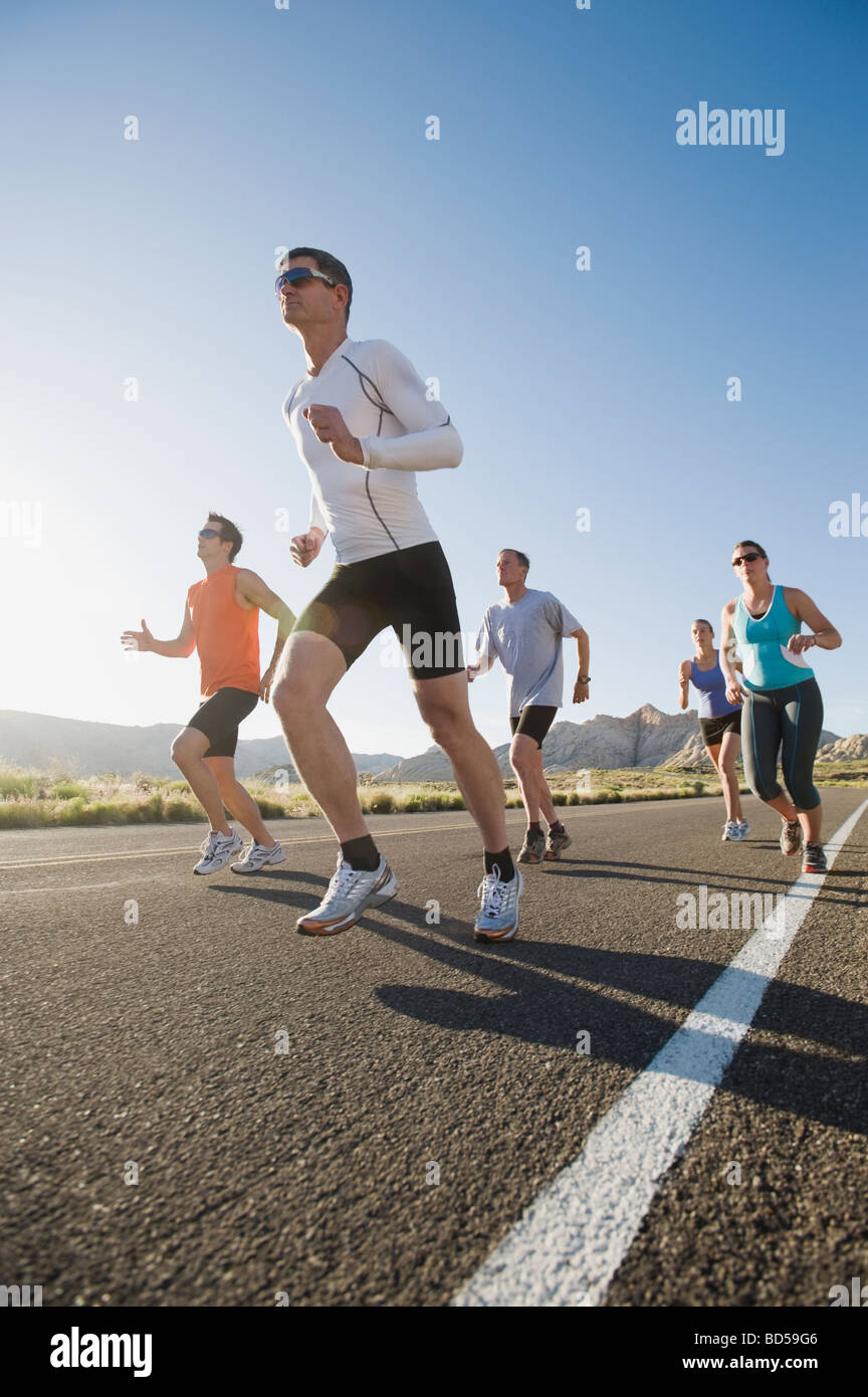 Runners on a road Stock Photo - Alamy