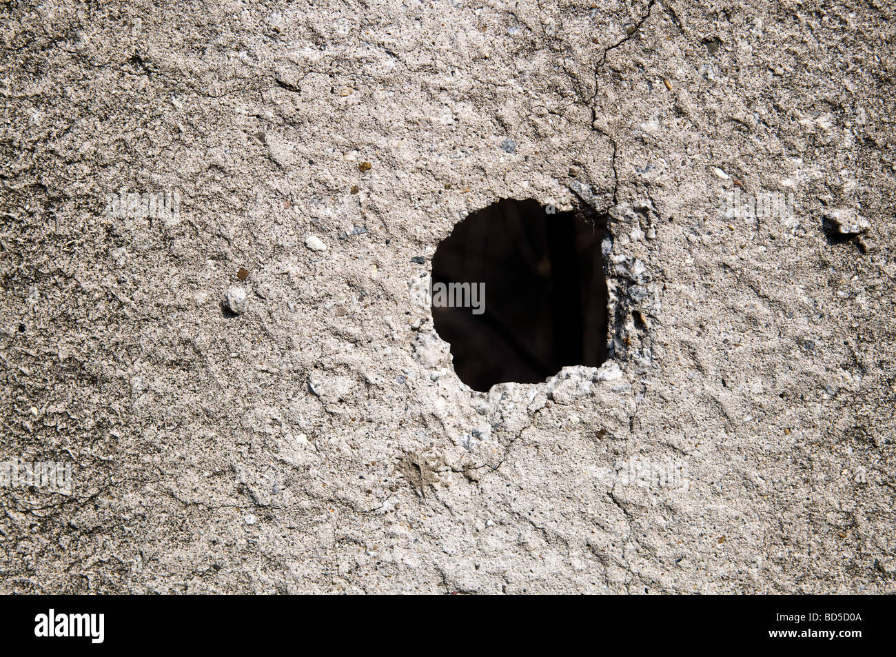 Hole in concrete wall structure Stock Photo