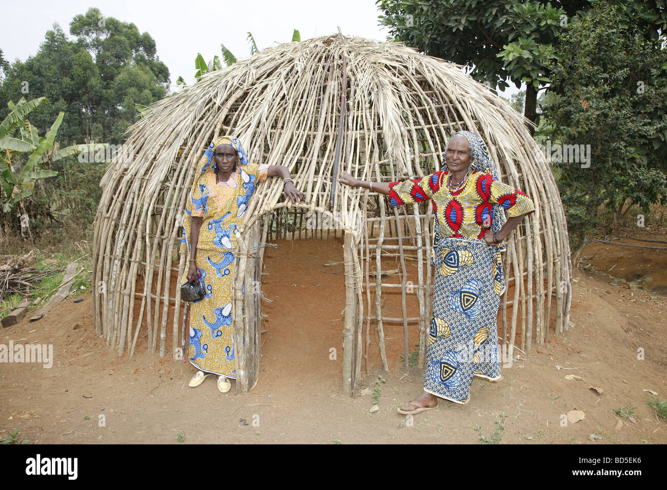 Women in front of the framework of a round hut, Mbororo ethnic group, Bamenda, Cameroon, Africa Stock Photo