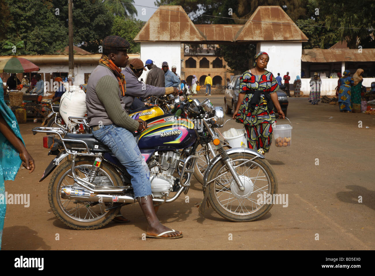 Man with motorcycle on the market, Sultan's Palace, Foumban, Cameroon, Africa Stock Photo