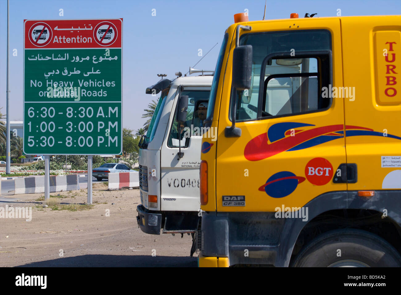 Trucks waiting because they are prohibited from using the streets during certain hours each day in Dubai, United Arab Emirates Stock Photo