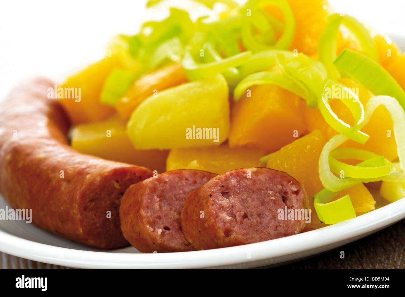 Turnip dish with leeks and Mettwurst sausage Stock Photo
