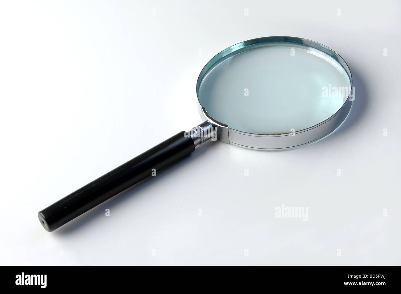 Close up of magnifying glass over a light background Stock Photo
