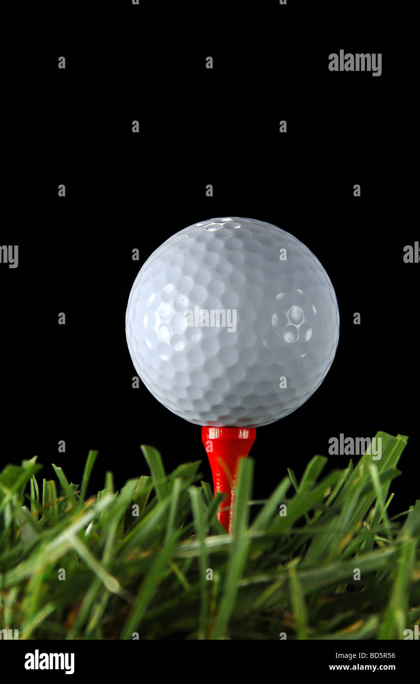 Golf ball and tee over a black background Stock Photo - Alamy