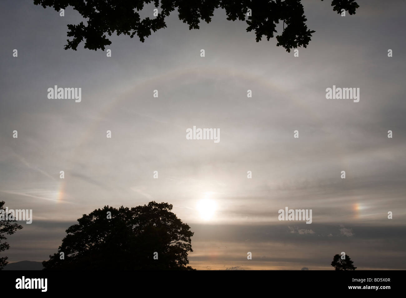 A rainbow around the sun caused by refraction from ice crystals in high level cloud Stock Photo