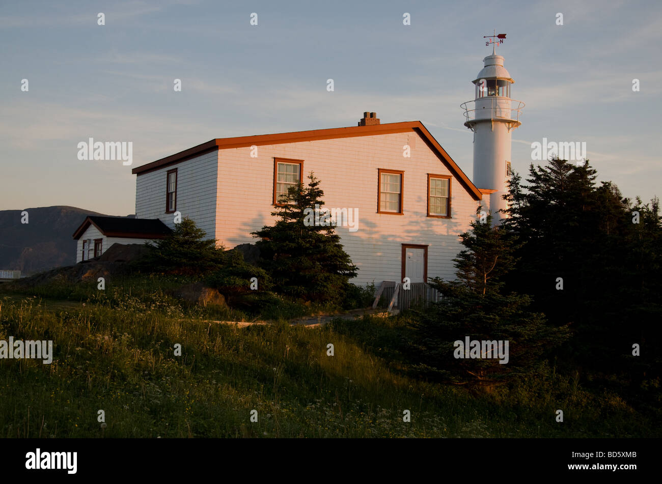 The Lobster Cove Head lighthouse lit by a setting sun Stock Photo Alamy