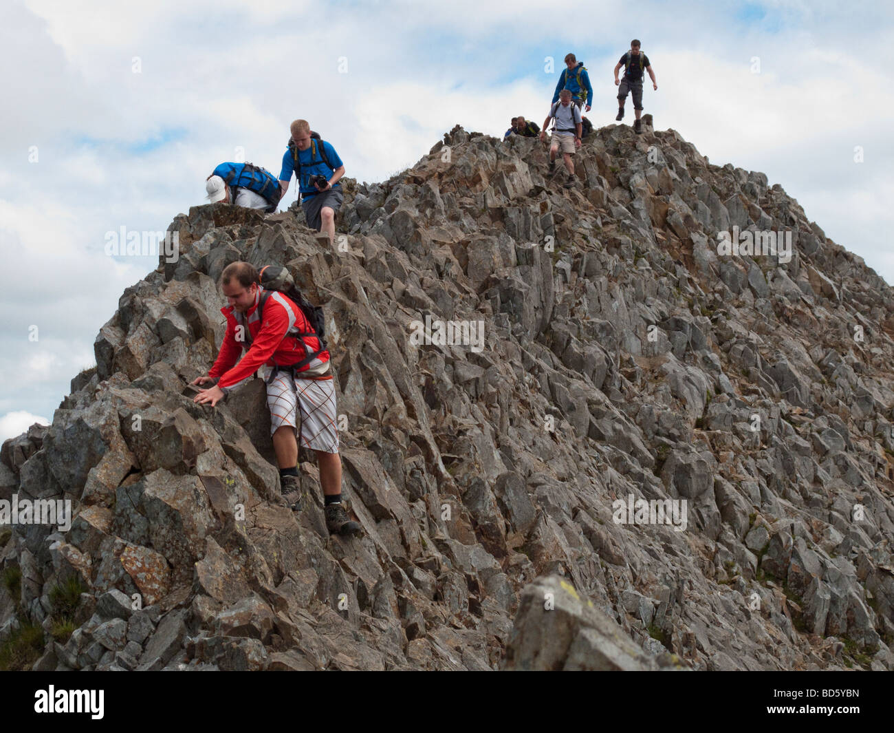 Walkers scramble along Crib Goch's knife edge ridge in Snowdonia, North Wales Stock Photo Alamy