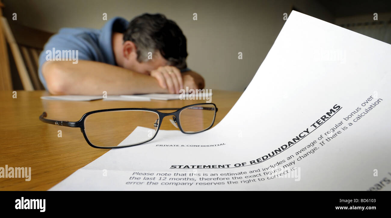 DISTRAUGHT MAN WITH LETTER SHOWING STATEMENT OF REDUNDANCY TERMS Stock Photo