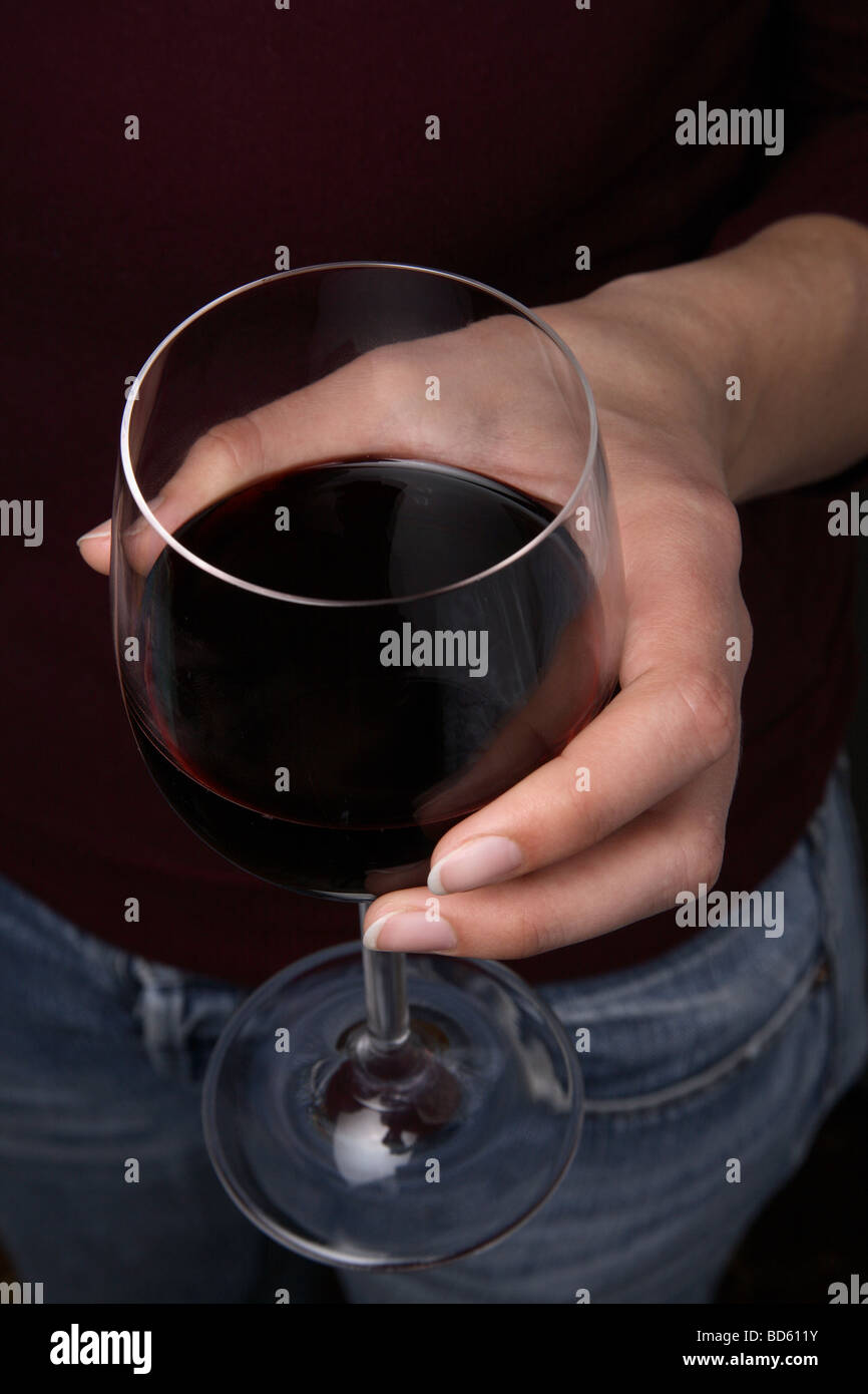 Woman's hand holding a glass of red wine Stock Photo