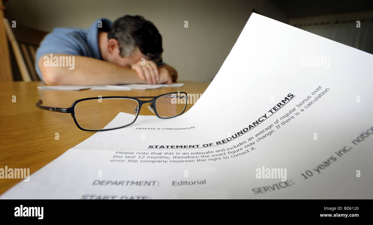 DEPRESSED MAN WITH LETTER SHOWING STATEMENT OF REDUNDANCY TERMS,UK Stock Photo