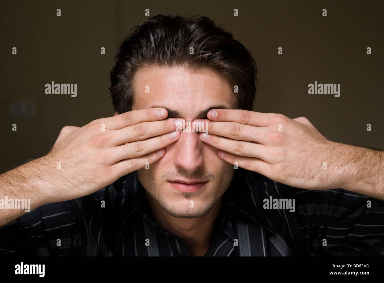Young man hands covering eyes Stock Photo - Alamy