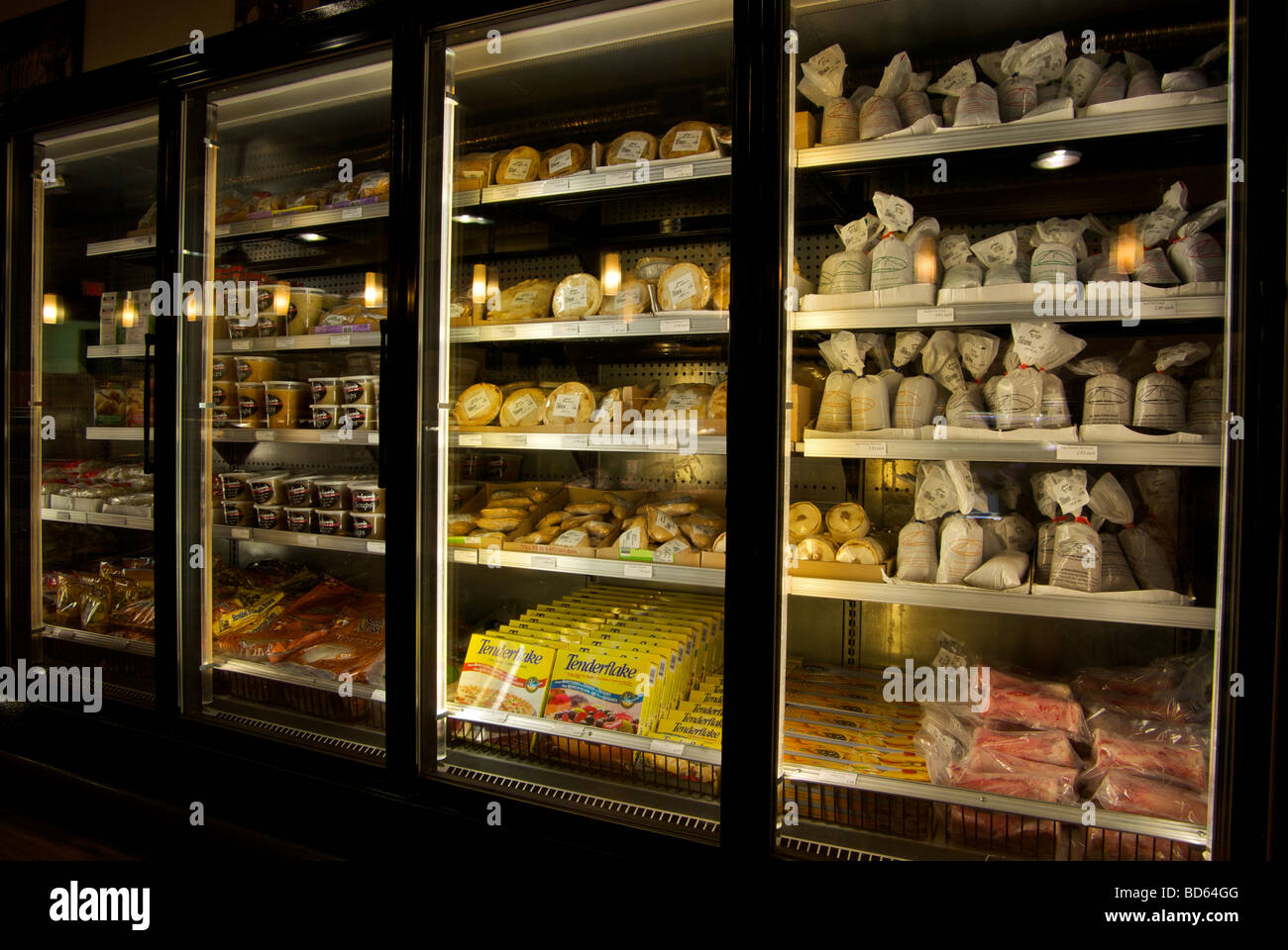 Upright freezer display case in small retail grocery store Stock Photo