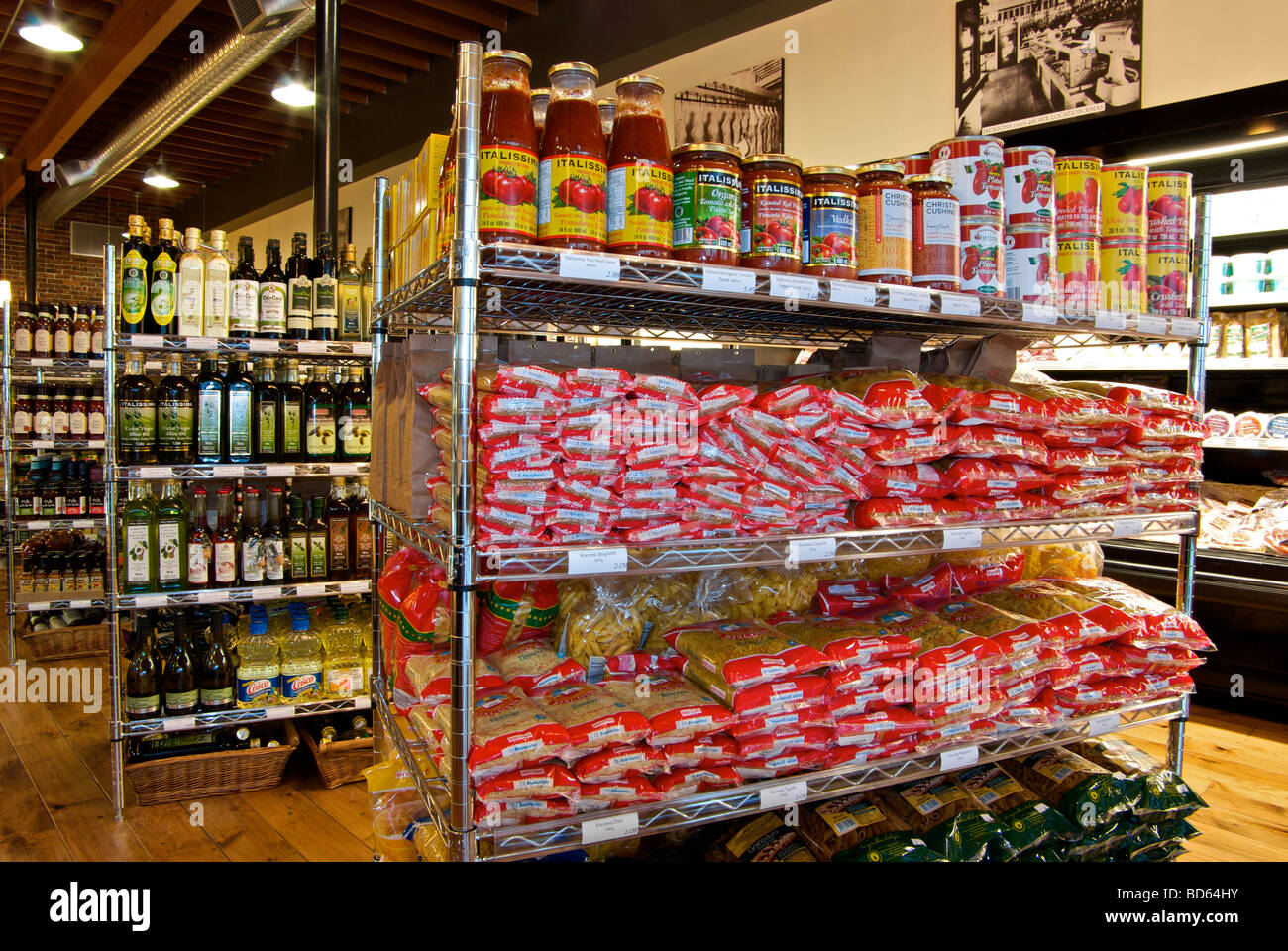 Centre aisle shelving in grocery store with dried canned foods pastas vegetables bottled condiments sauces Stock Photo