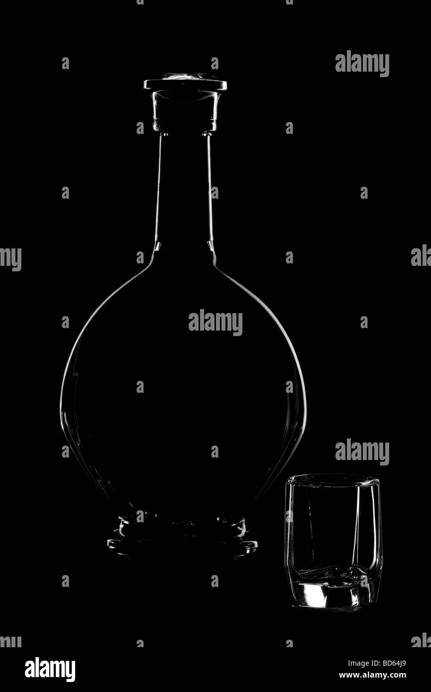 Cognac bottle and glass isolated on black background Stock Photo
