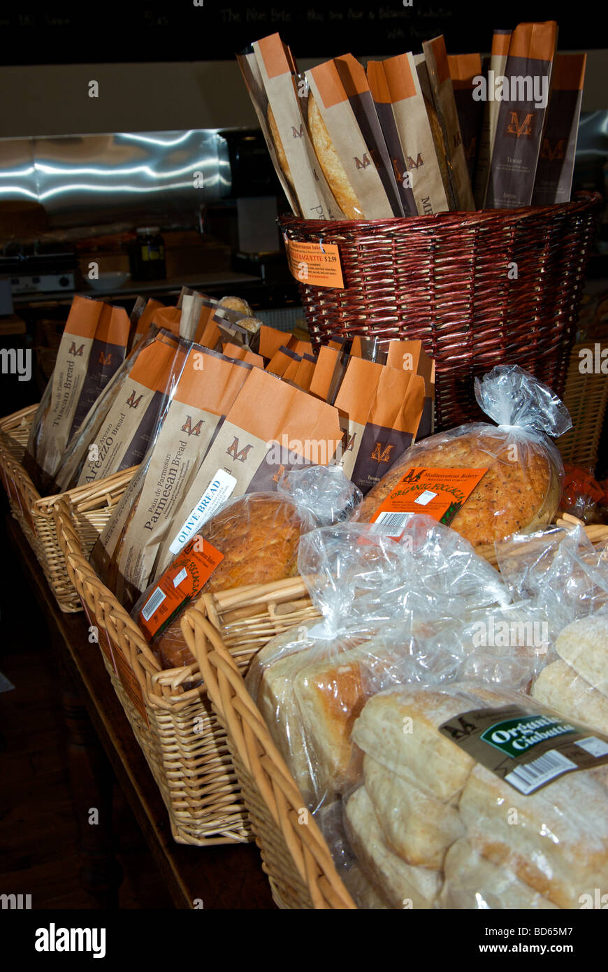 Selection of crusty breads buns in baskets in deli section of grocery