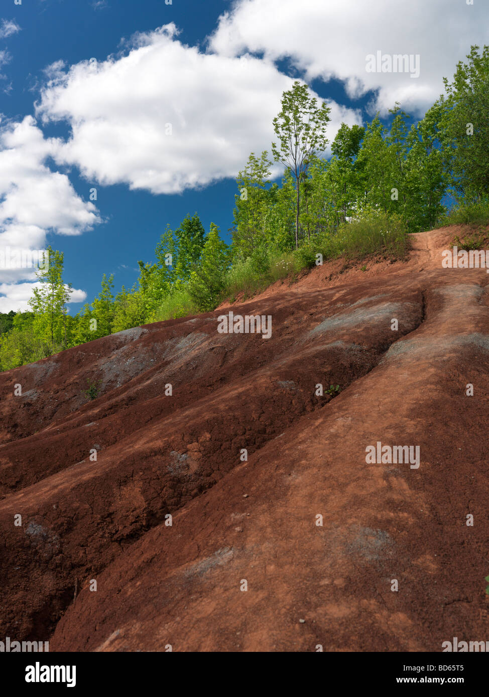 Badlands landscape formed by red and gray dry eroded clay Stock Photo
