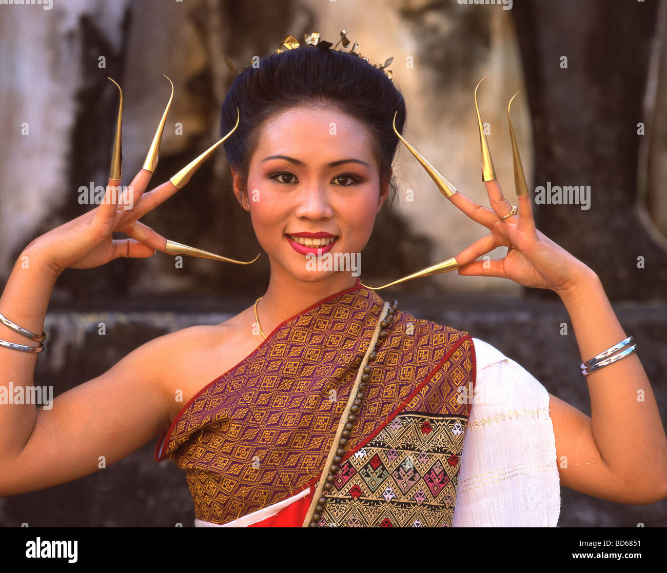 A pretty girl with the traditional dress and nails of Thailand. Chiang Mai Stock Photo