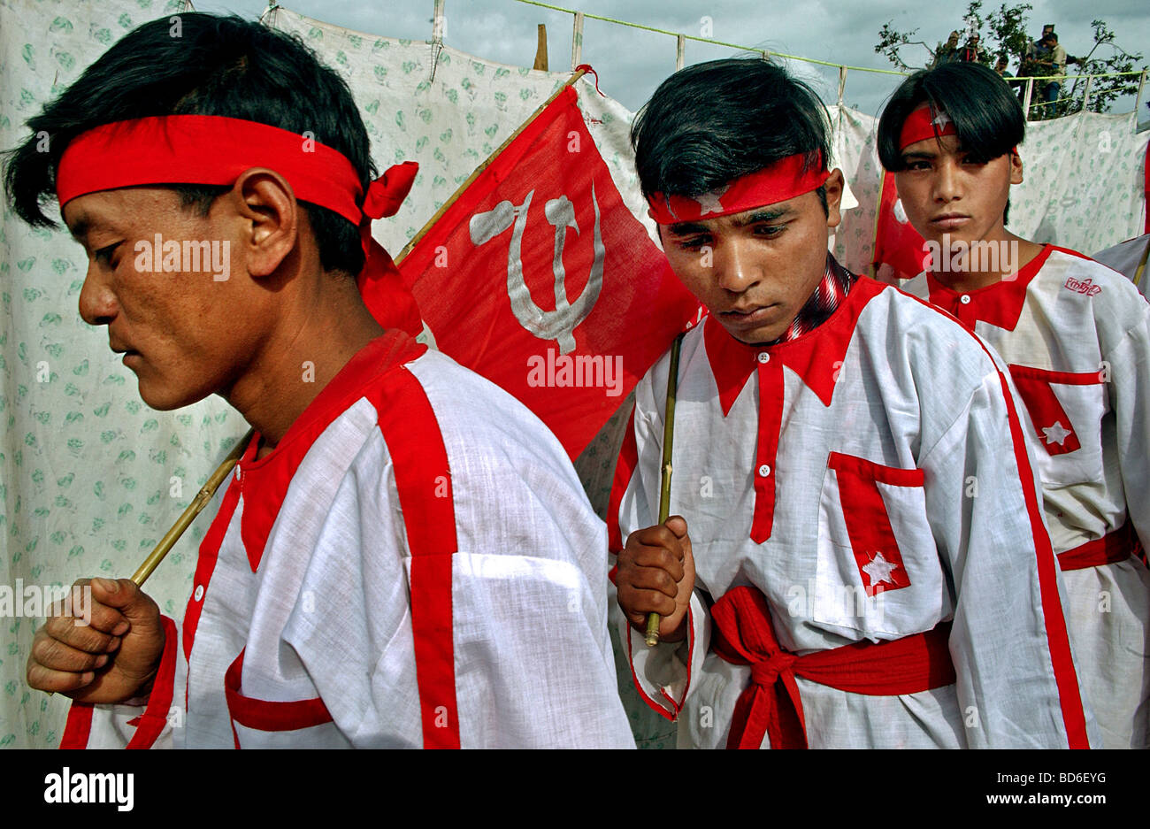 Maoists perform a traditional dance with Communist flags during a cultural program where over 1000 villagers came from several Stock Photo