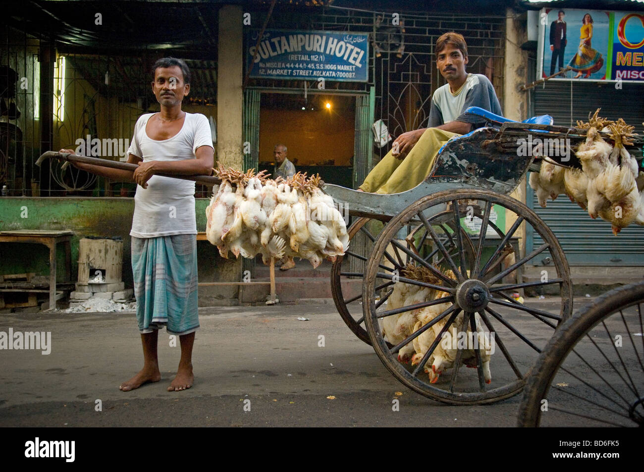 Chickens hang from rickshaws on their way to the market. (Photo by Ami ...