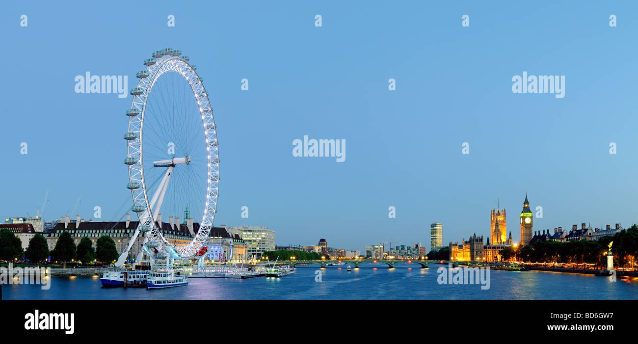 Panoramic shot of the London skyline at dusk, with London Eye at left and Houses of Parliament at right Stock Photo