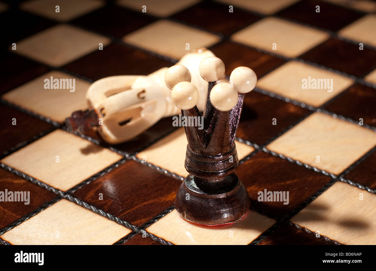 Chess Board with queen and defeated king Stock Photo