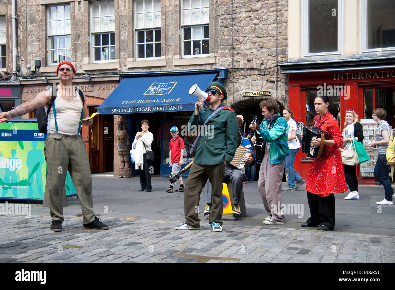 A man singing into a megaphone as part of a street act performing in Edinburgh's Fringe Festival 2009 Stock Photo
