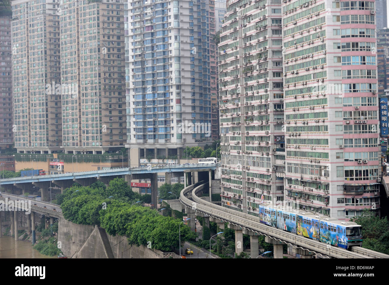 Chongqing metro train across high density apartments. 02-Aug-2009 Stock Photo