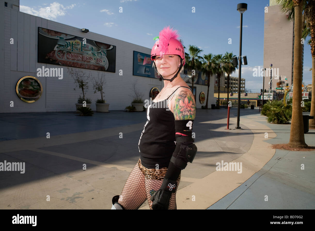 A rollergirl poses for a photo at the Fremont Street Experience roller derby exhibition during the 2009 Las Vegas RollerCon Stock Photo