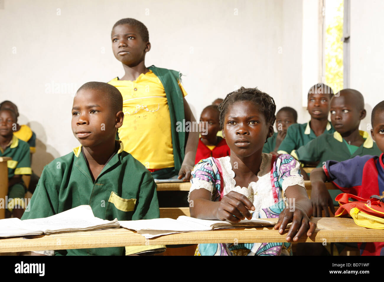 Girl without uniforms with classmates in uniform, during lessons, Mora, Cameroon, Africa Stock Photo