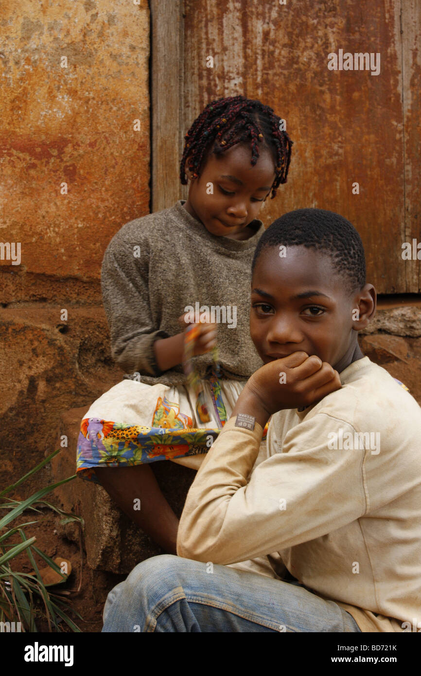 Boy and girl in front of a door, Bafoussam, Cameroon, Africa Stock Photo