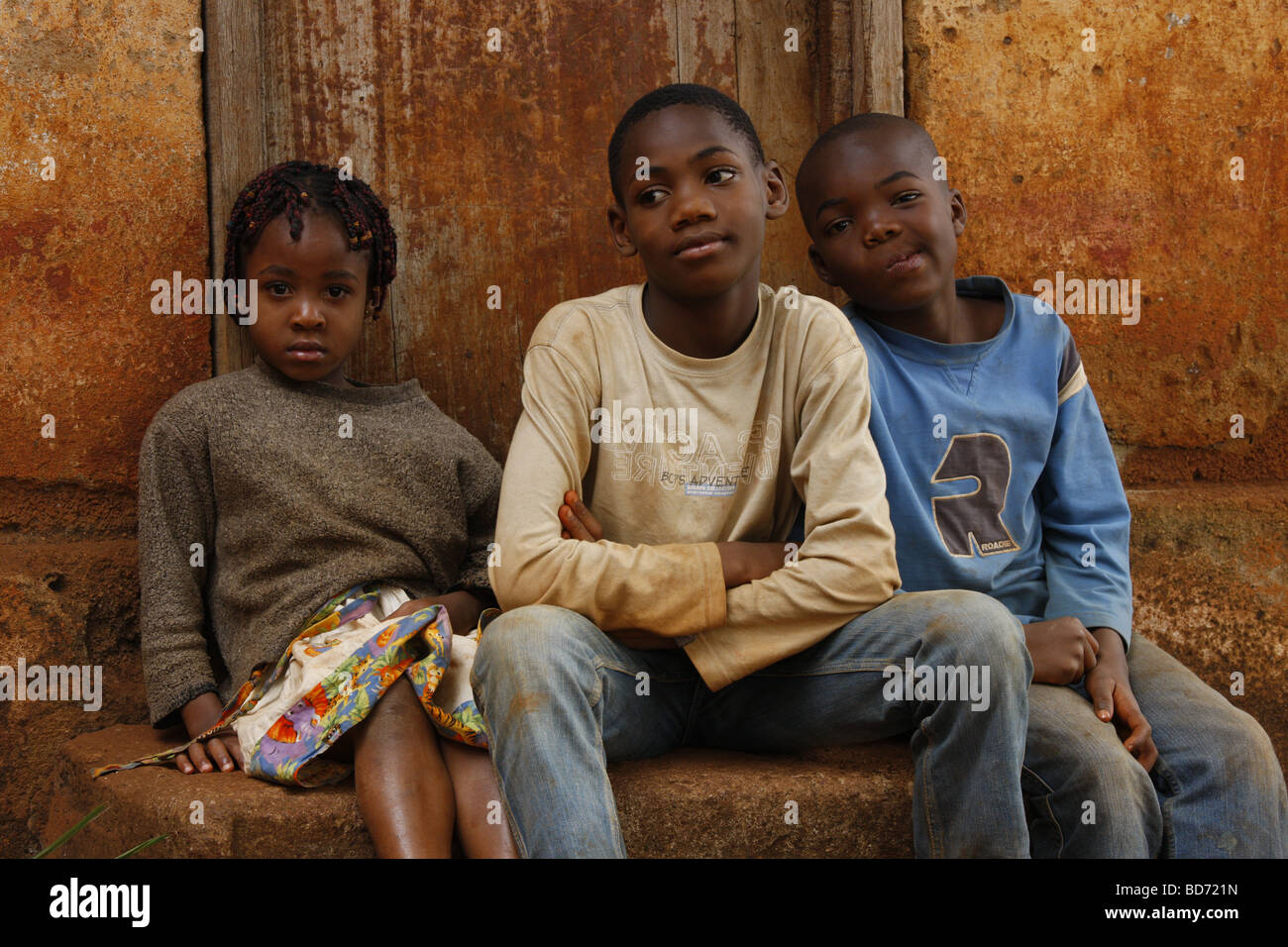 Boys and girl in front of a door, Bafoussam, Cameroon, Africa Stock Photo