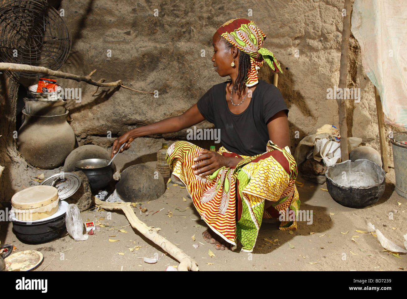 Woman cooking at the fireplace in a house, Maroua, Cameroon, Africa