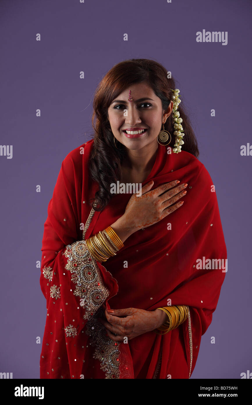 Indian woman with hand on chest Stock Photo