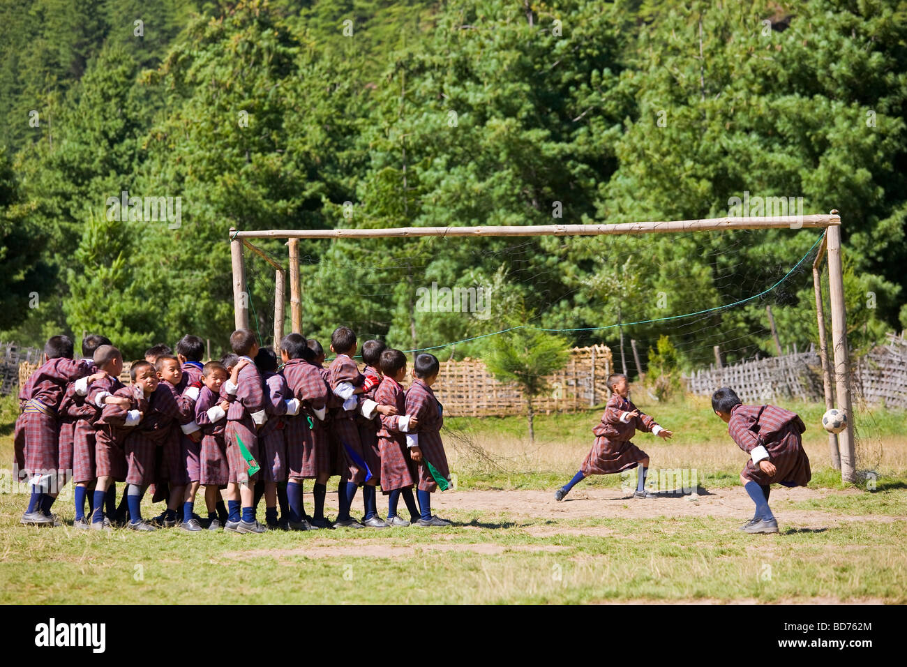 Boys practising penalties at football Jakar Bhutan Stock Photo