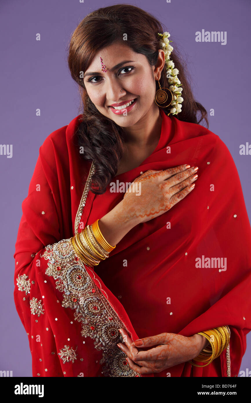 Indian woman with hand on chest Stock Photo