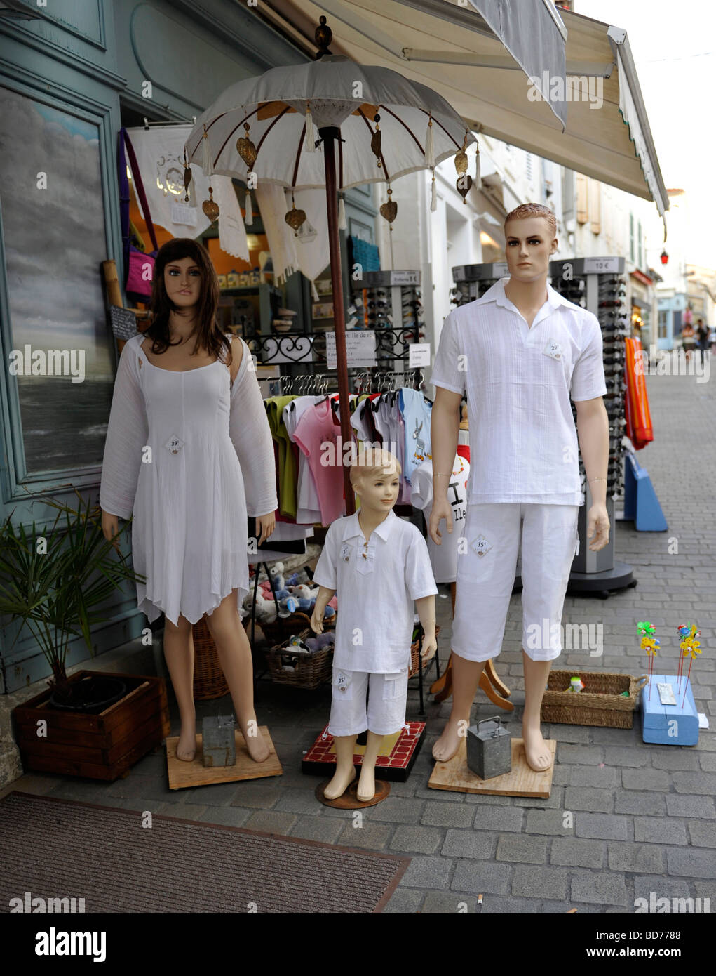 A family of mannequins dressed in white outside a shop in France, St martin. Ile de Re Stock Photo