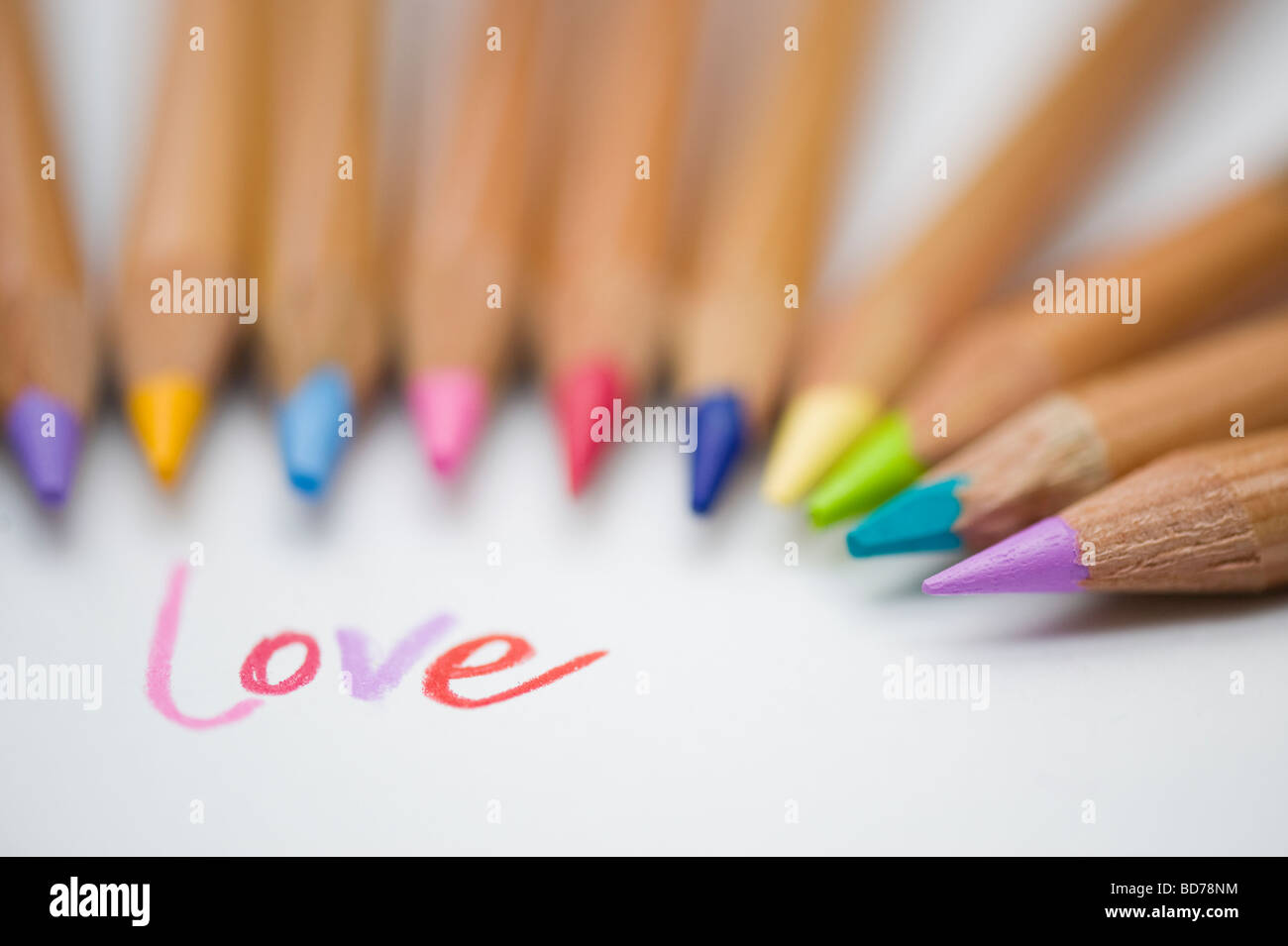 Coloured love word on paper and colouring pencils Stock Photo