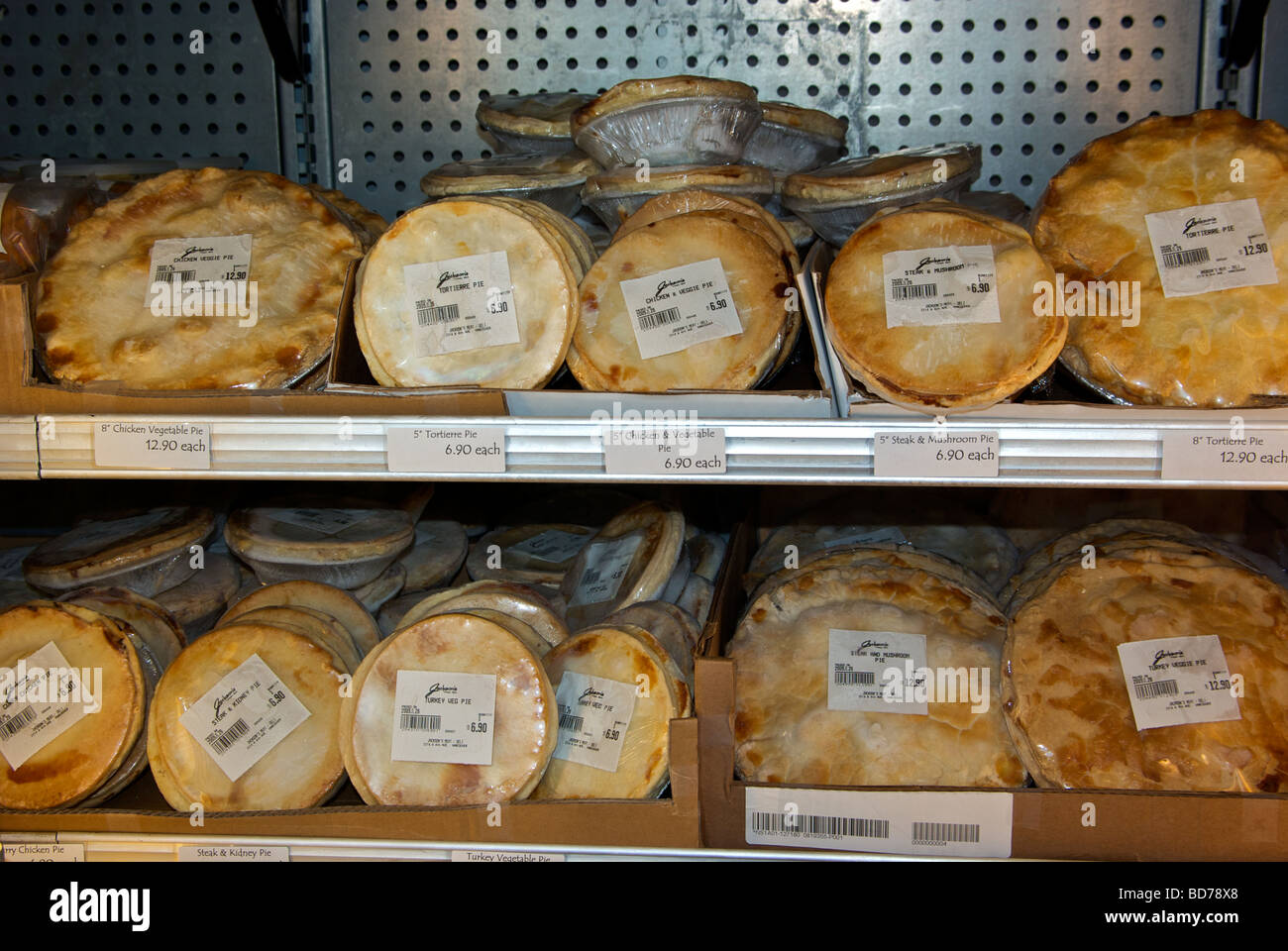 Frozen savoury meat pies in upright display freezer case Stock Photo