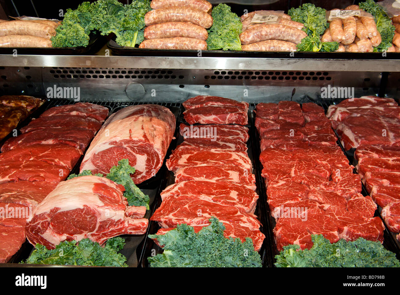 Display cooler case trays of beef steaks roasts sausages Stock Photo ...