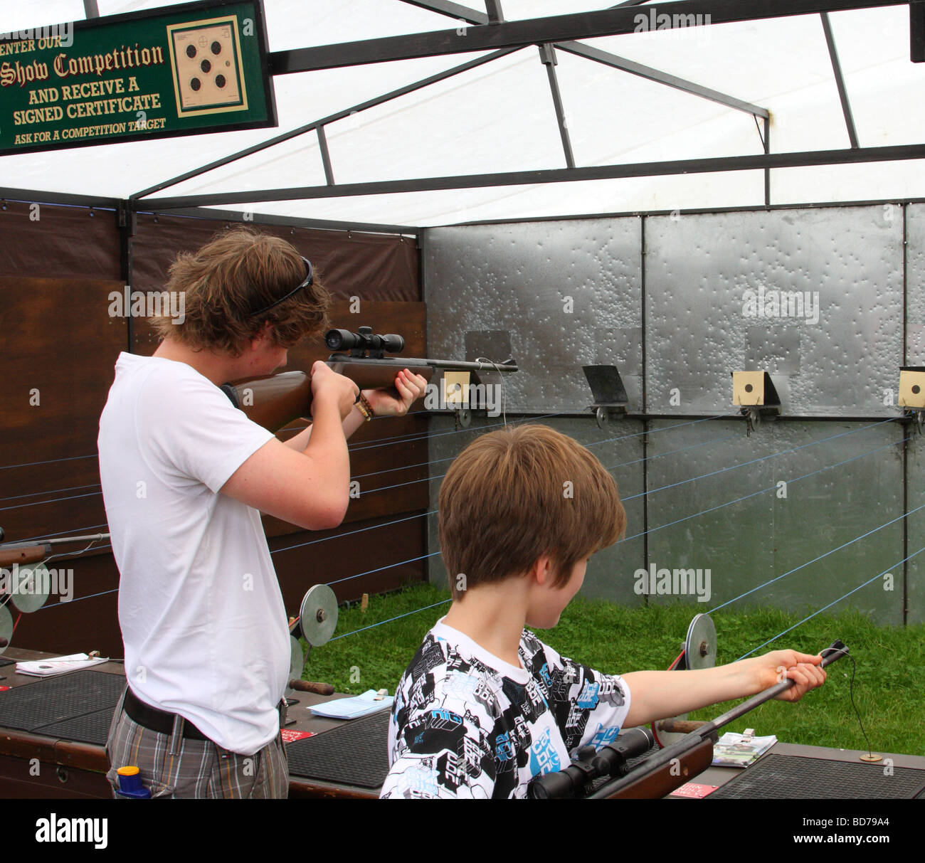 Teenagers on a shooting range at an English country show. Stock Photo