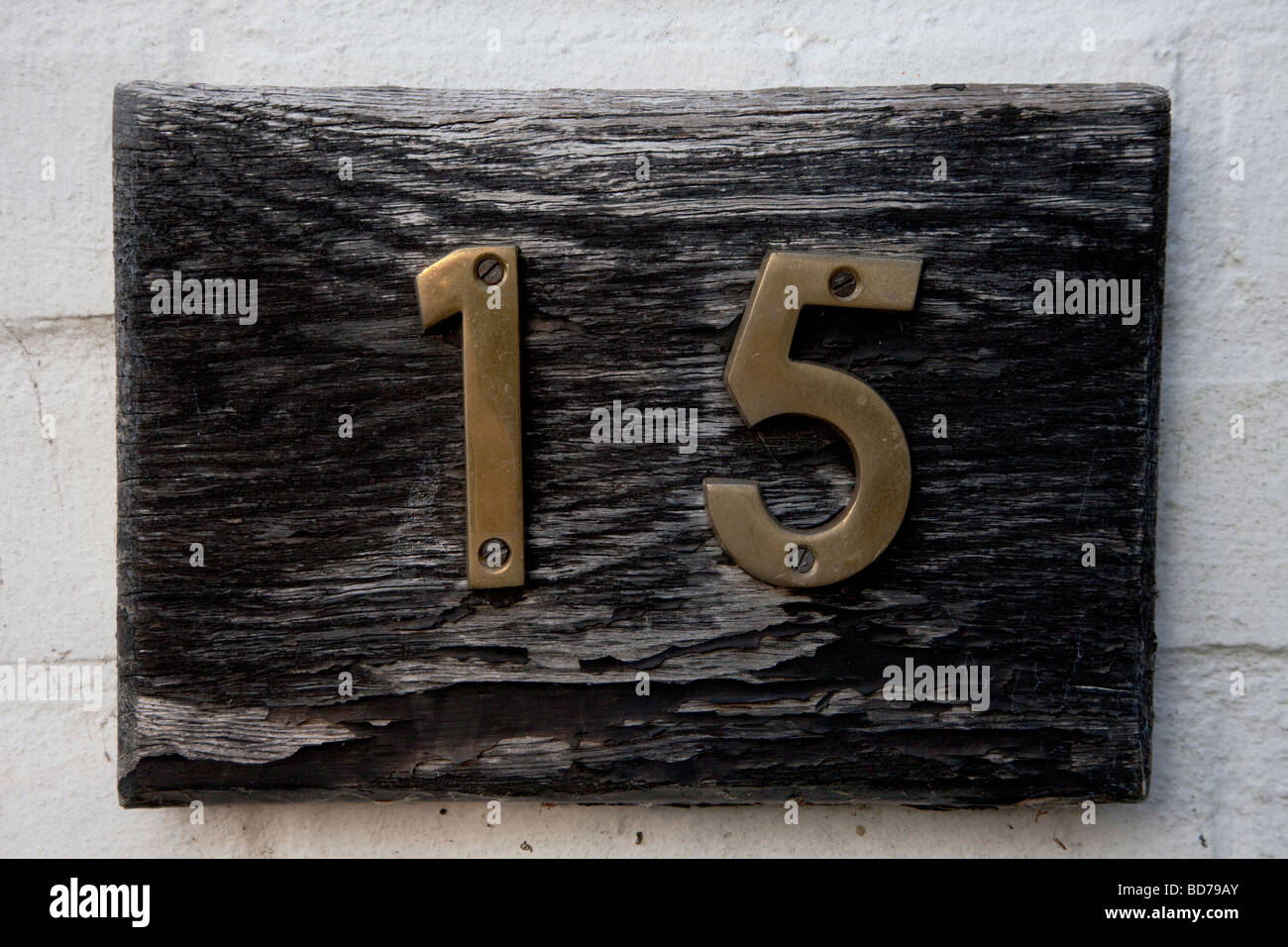 Number fifteen on a wooden plaque. Stock Photo