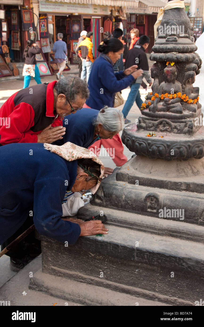 Bodhnath, Nepal.  Worshipers Pray at a Shrine at the Base of the Bodhnath Stupa, a Tibetan Buddhist Stupa. Stock Photo